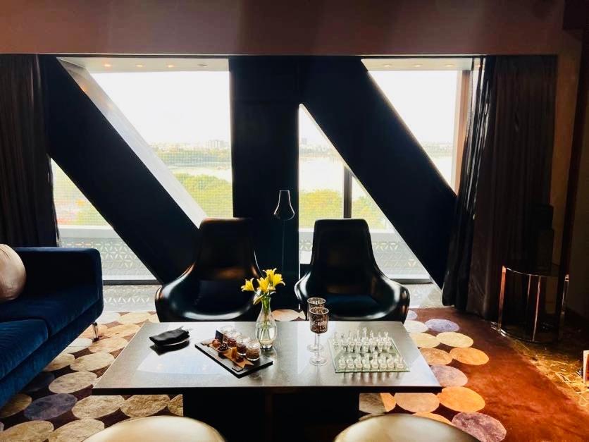 a living room with a table and two chairs and a keyboard at The Park Hyderabad, Banjara Hills near Hussain Sagar Lake in Hyderabad a living room with a table and two chairs and a keyboard at The Park Hyderabad, Banjara Hills near Hussain Sagar Lake in Hyderabad