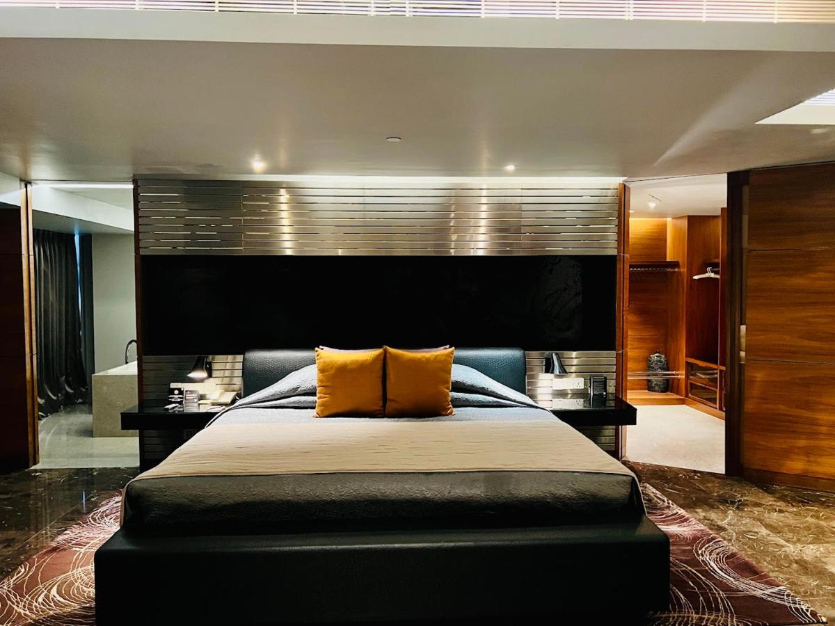 a bedroom with a large bed with yellow pillows at The Park Hyderabad, Banjara Hills near Hussain Sagar Lake in Hyderabad a bedroom with a large bed with yellow pillows at The Park Hyderabad, Banjara Hills near Hussain Sagar Lake in Hyderabad