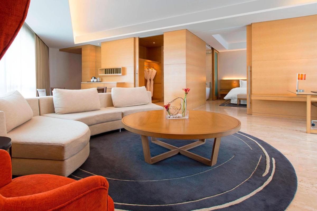 a living room with a couch and a table at The Westin Mumbai Garden City in Mumbai