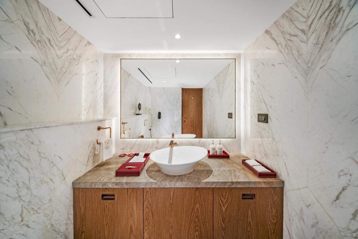 a bathroom with a sink and a mirror at Radisson Blu Hotel & Suites GRT Chennai in Chennai