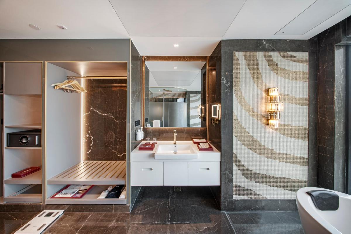 a bathroom with a sink and a mirror at Radisson Blu Hotel & Suites GRT Chennai in Chennai