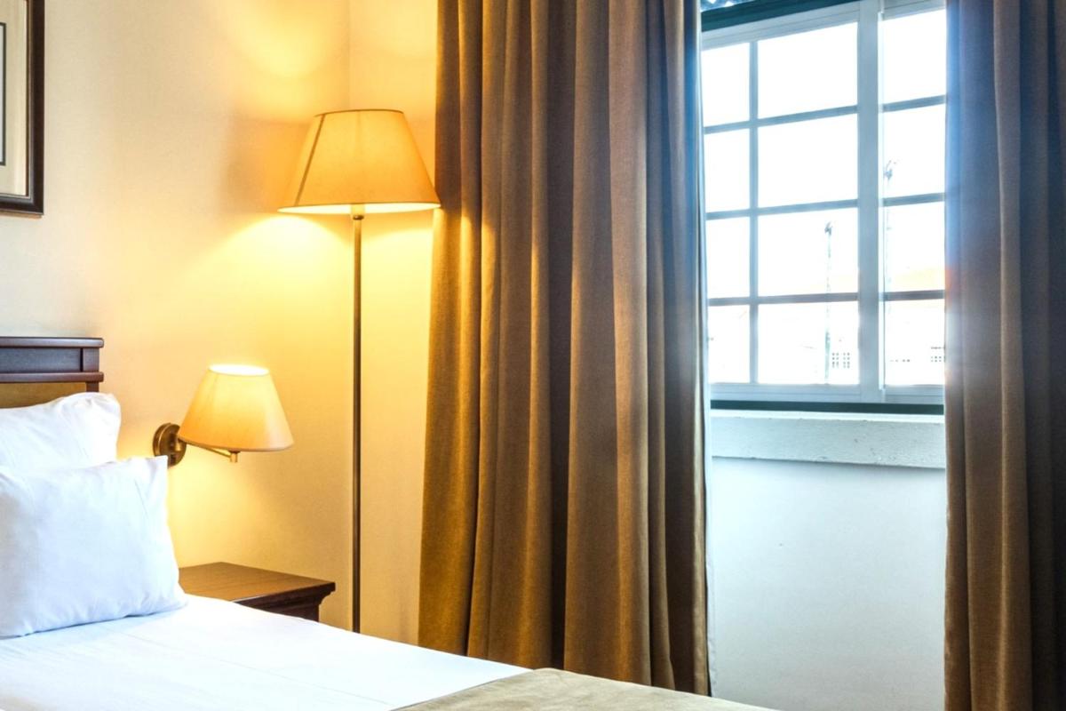 Uma cama ou camas num quarto em Vila Gale Ericeira