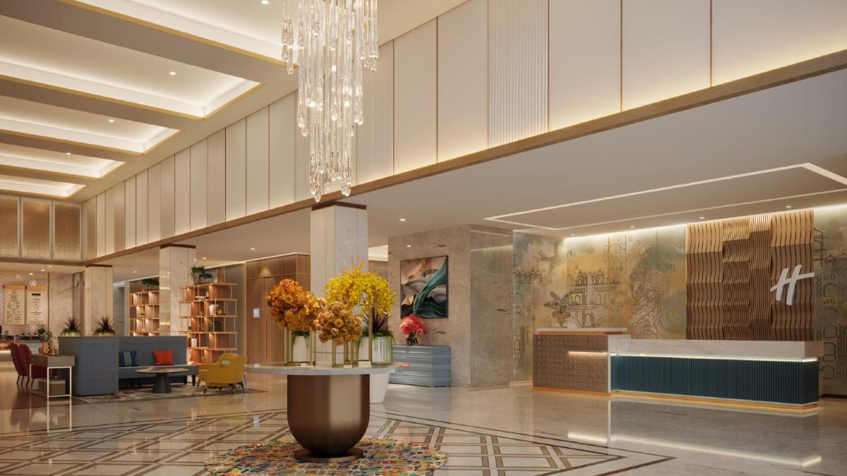 a lobby with a table with flowers on it at Holiday Inn Lucknow Airport by IHG in Lucknow +111 photos