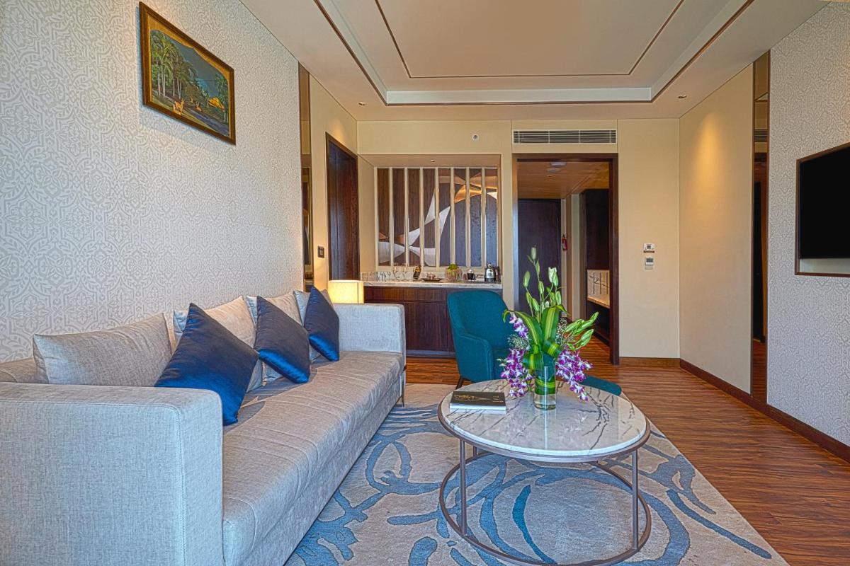 a living room with a couch and a table at Taj Bangalore in Devanahalli-Bangalore