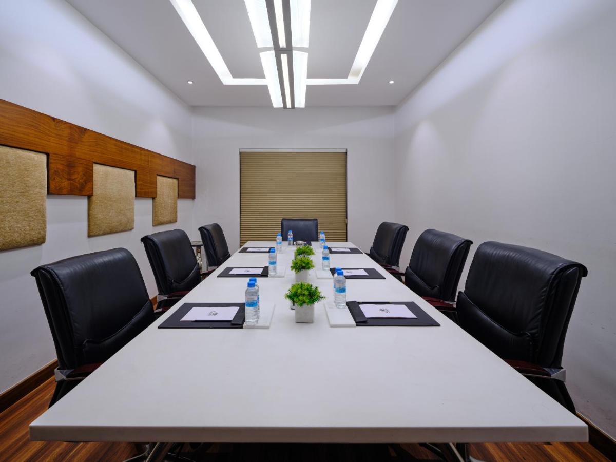 a conference room with a long table and chairs at Sayaji Pune in Pune