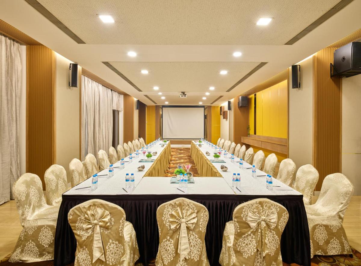 a long meeting room with a long table and chairs at Sayaji Pune in Pune