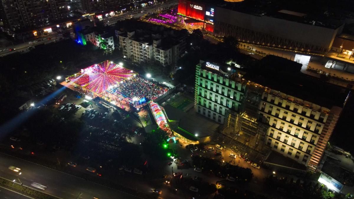 a ferris wheel in a city at night at Sayaji Pune in Pune