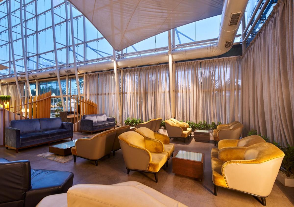a lobby with couches and chairs in a building at Sayaji Pune in Pune