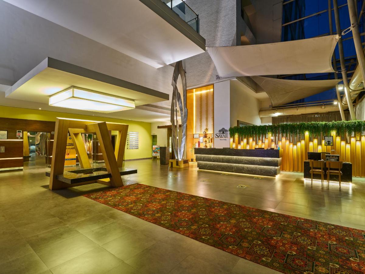 a lobby with a couch and a rug at Sayaji Pune in Pune