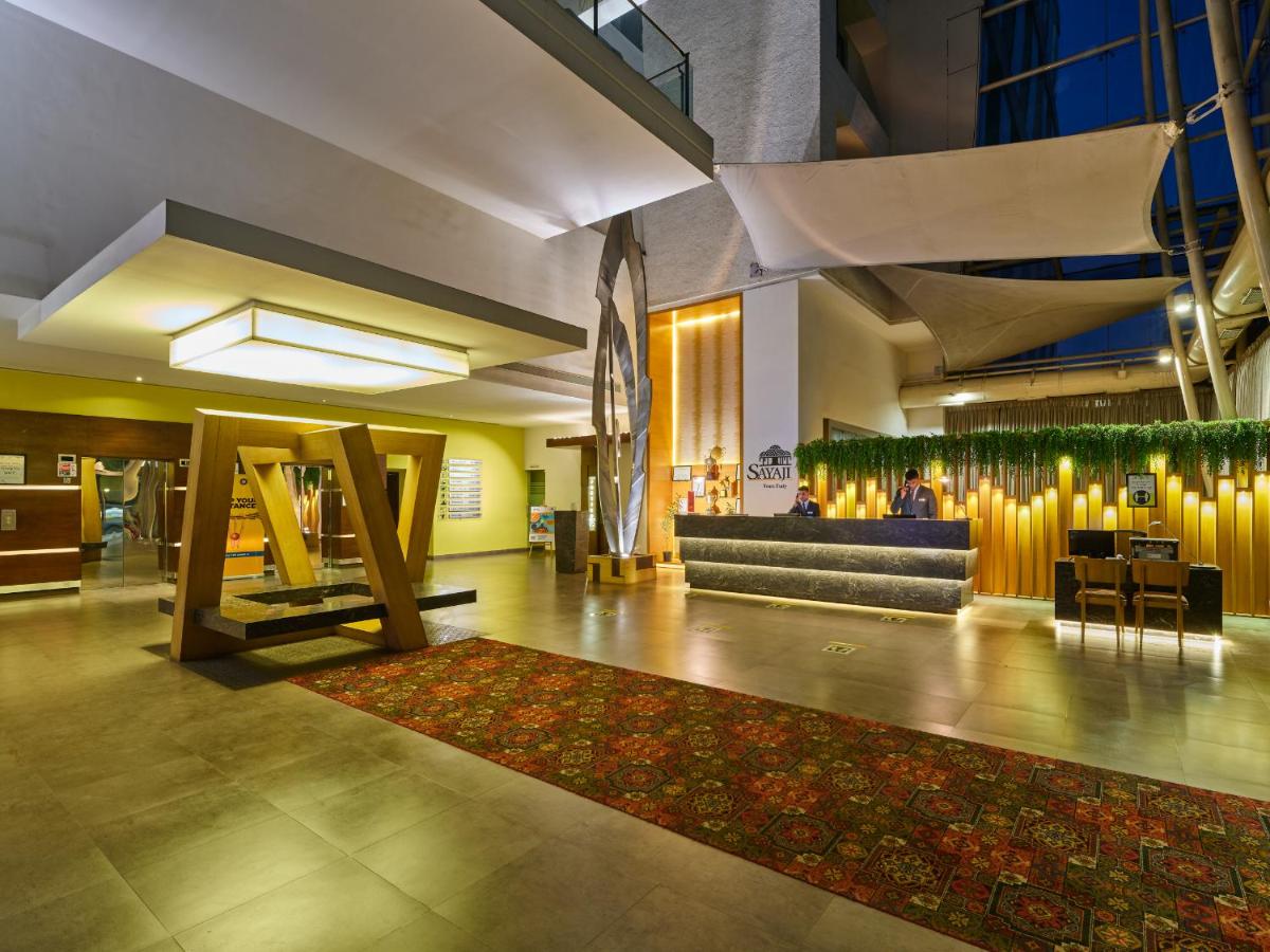 a lobby with a couch and a rug at Sayaji Pune in Pune