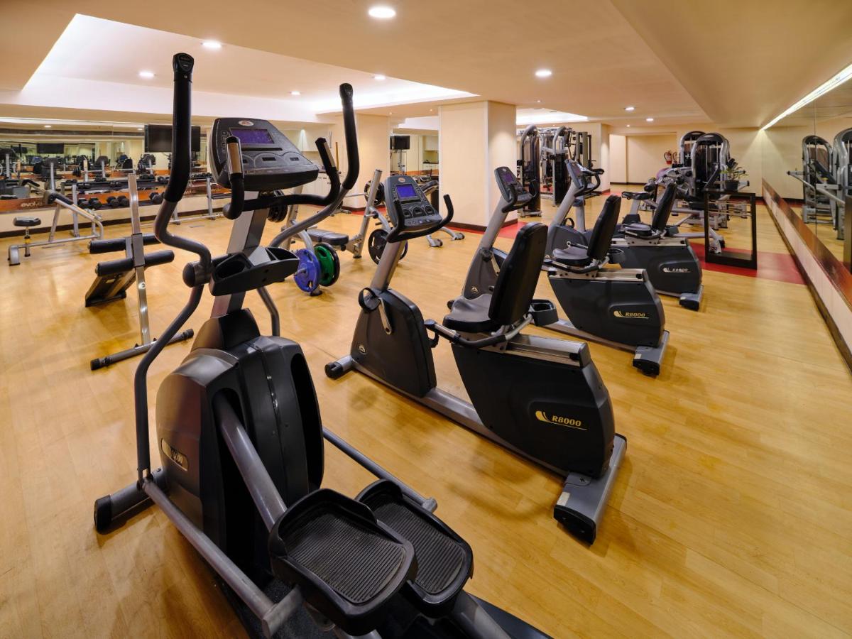 a gym with a row of cardio machines at Sayaji Pune in Pune