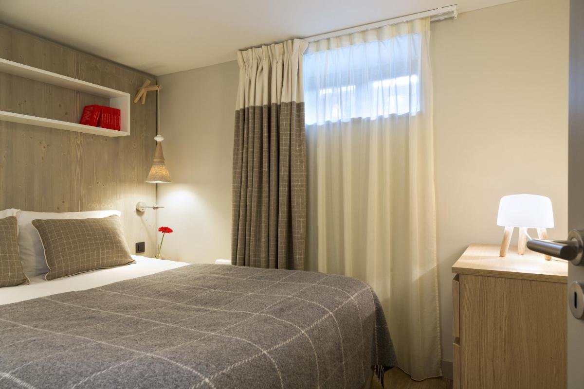 Un ou plusieurs lits dans un hébergement de l'établissement Appartements de l'Héliopic