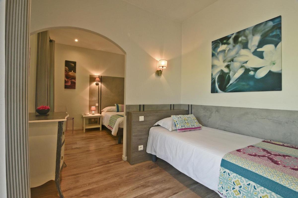 Un ou plusieurs lits dans un hébergement de l'établissement Golfe Hôtel & Spa Porto-Vecchio