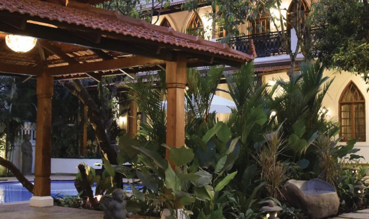 a garden in front of a building at The Postcard Saligao in Calangute