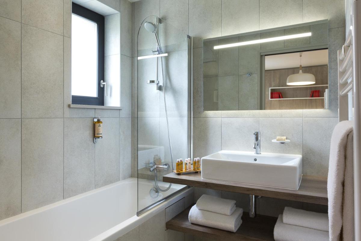 Salle de bains dans l'établissement Appartements de l'Héliopic