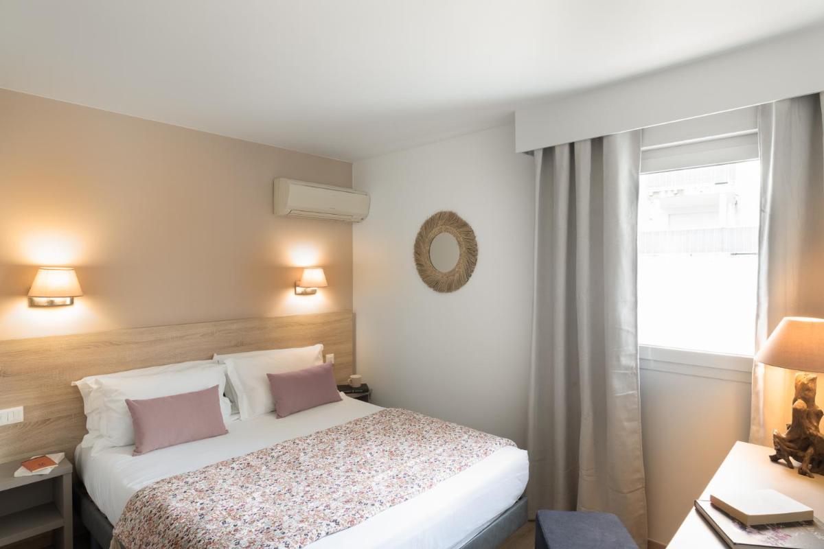 Un ou plusieurs lits dans un hébergement de l'établissement Golfe Hôtel & Spa Porto-Vecchio