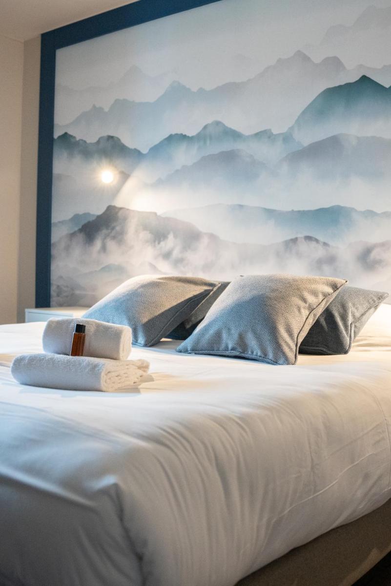 Un ou plusieurs lits dans un hébergement de l'établissement Hotel Le Bois Joli