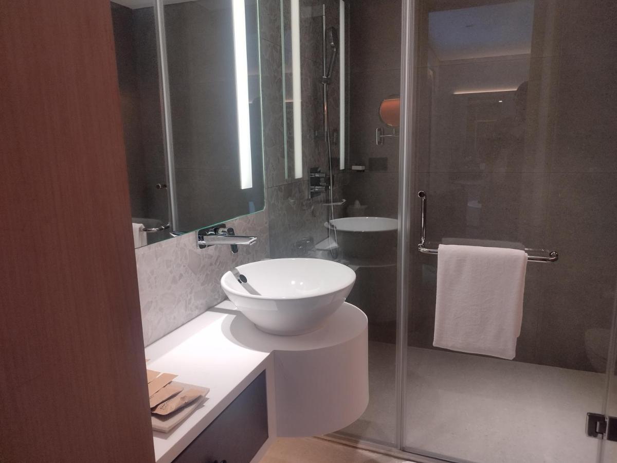 a bathroom with a white sink and a shower at Hyatt Centric Hebbal Bengaluru in Bengaluru