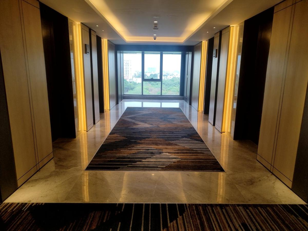 an empty hallway with a large window in a building at Hyatt Centric Hebbal Bengaluru in Bengaluru