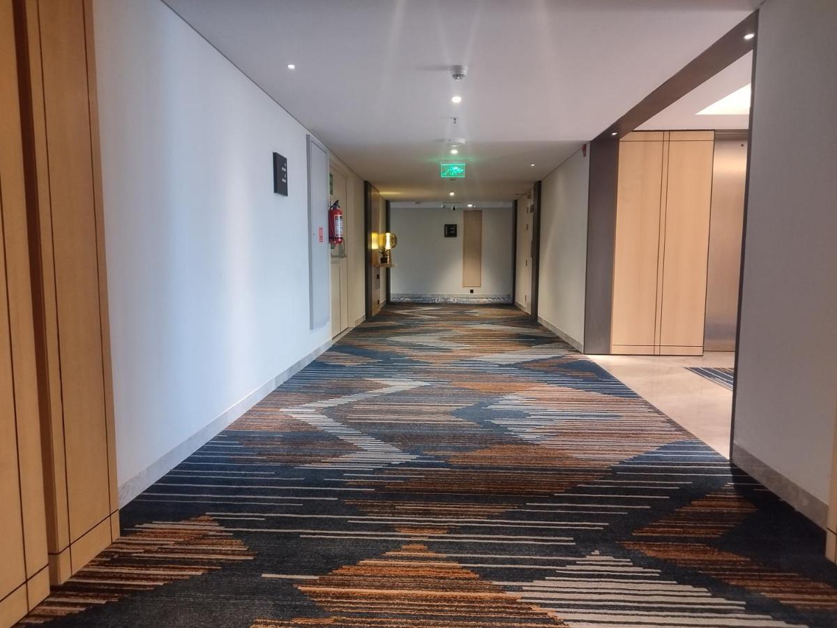 a hallway with a large rug on the floor at Hyatt Centric Hebbal Bengaluru in Bengaluru