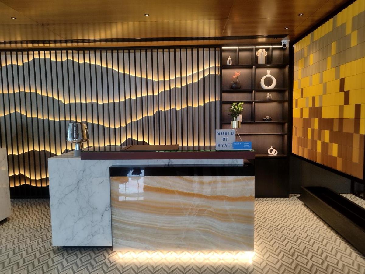 a lobby with a counter in a room at Hyatt Centric Hebbal Bengaluru in Bengaluru