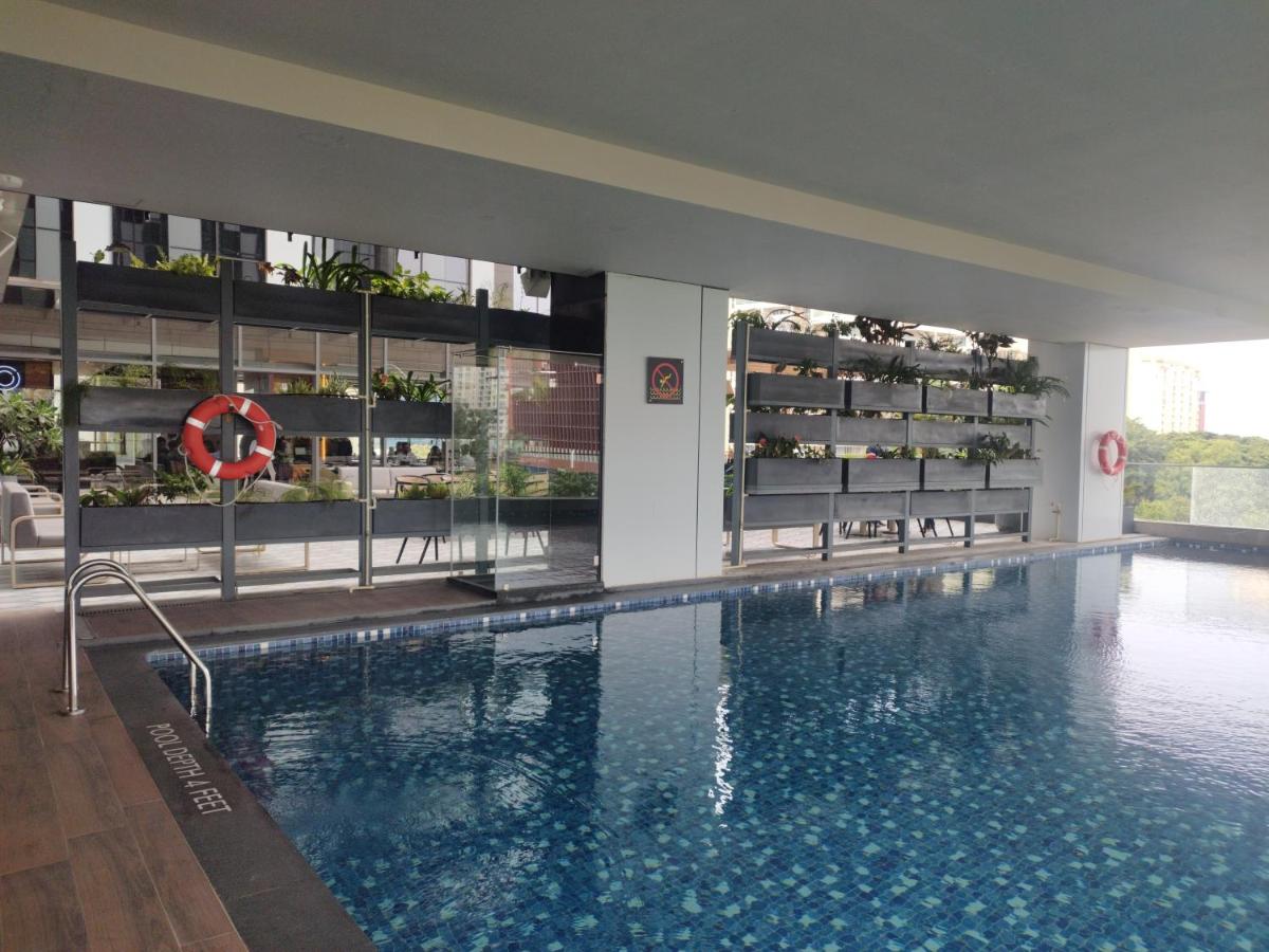 a large swimming pool in a building at Hyatt Centric Hebbal Bengaluru in Bengaluru
