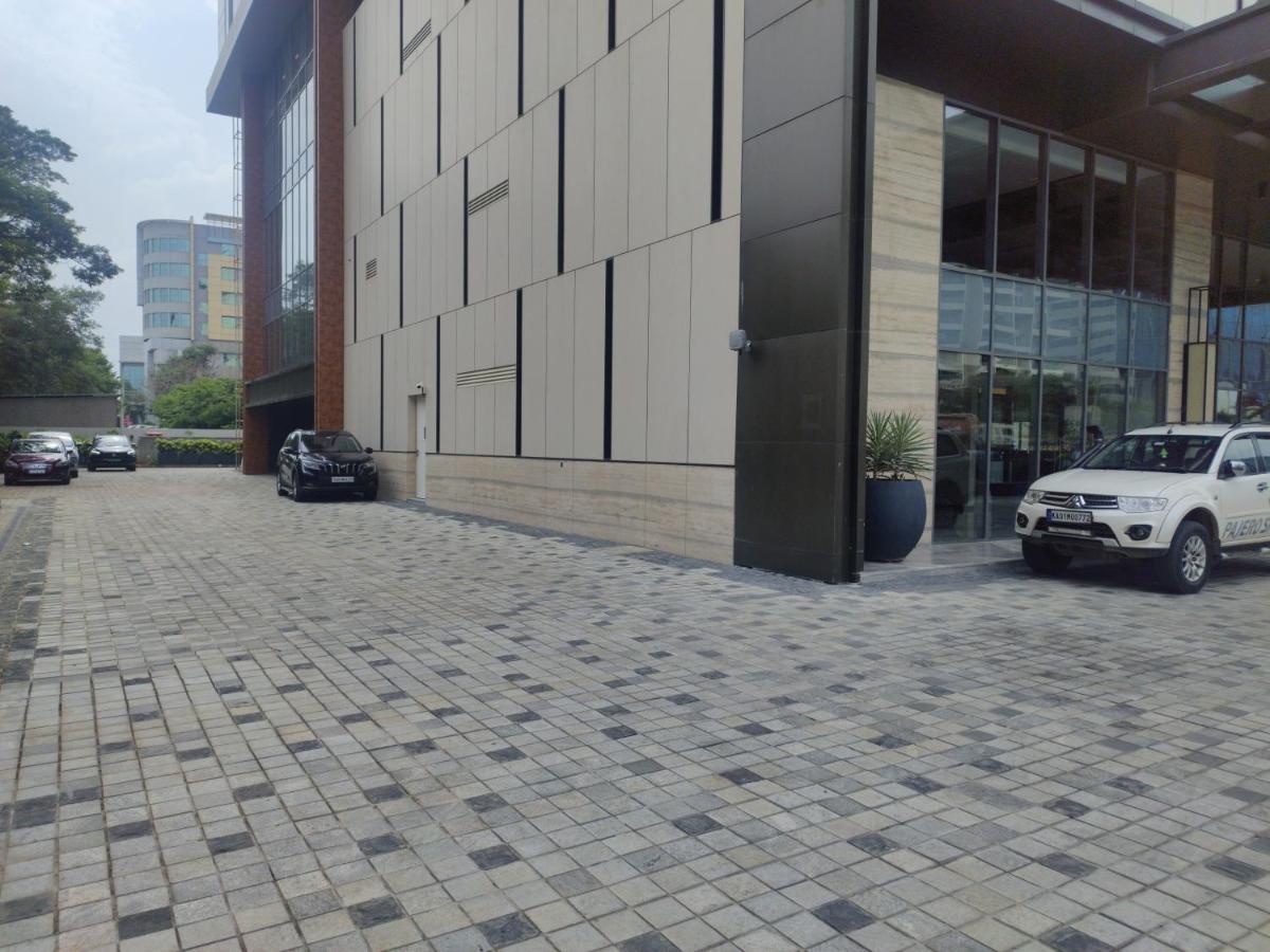 a white car parked outside of a building at Hyatt Centric Hebbal Bengaluru in Bengaluru