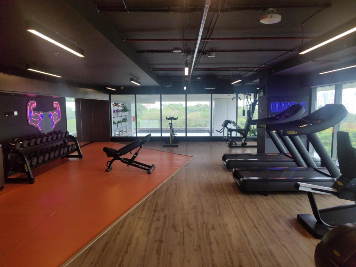 a gym with treadmills and ellipticals in a room at Hyatt Centric Hebbal Bengaluru in Bengaluru