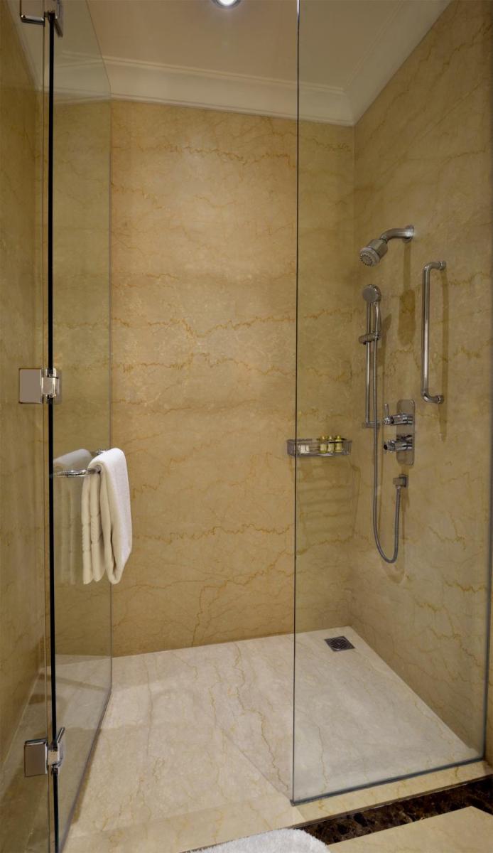 a shower with a glass door in a bathroom at Trident Gurgaon in Gurgaon