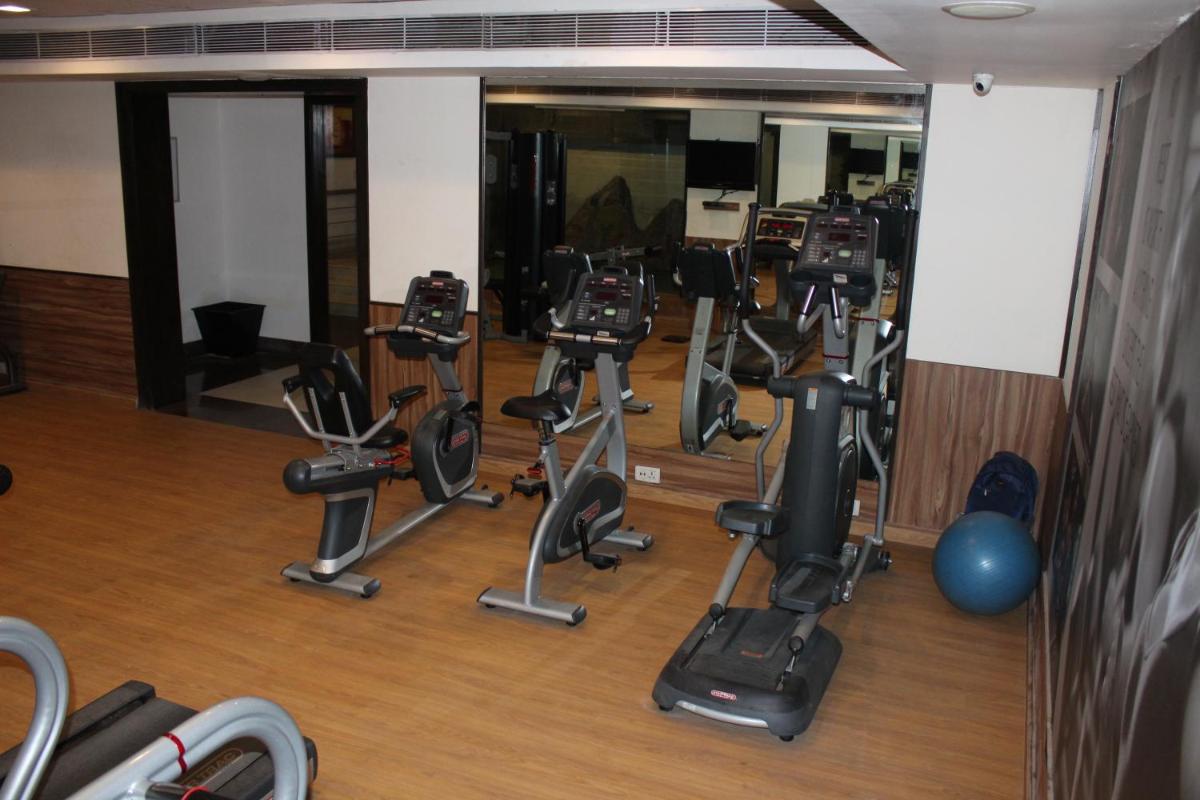 a gym with a bunch of exercise equipment in it at Pride Plaza Hotel, Ahmedabad in Ahmedabad