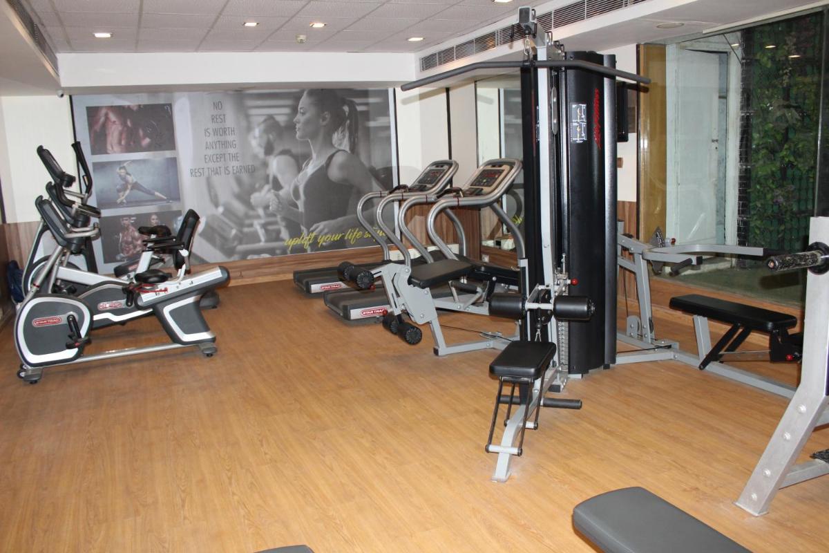 a gym with a bunch of exercise equipment in it at Pride Plaza Hotel, Ahmedabad in Ahmedabad
