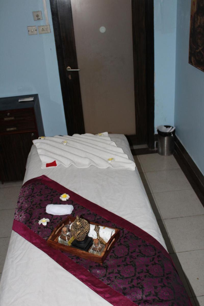 a bed with a tray of items on it at Pride Plaza Hotel, Ahmedabad in Ahmedabad