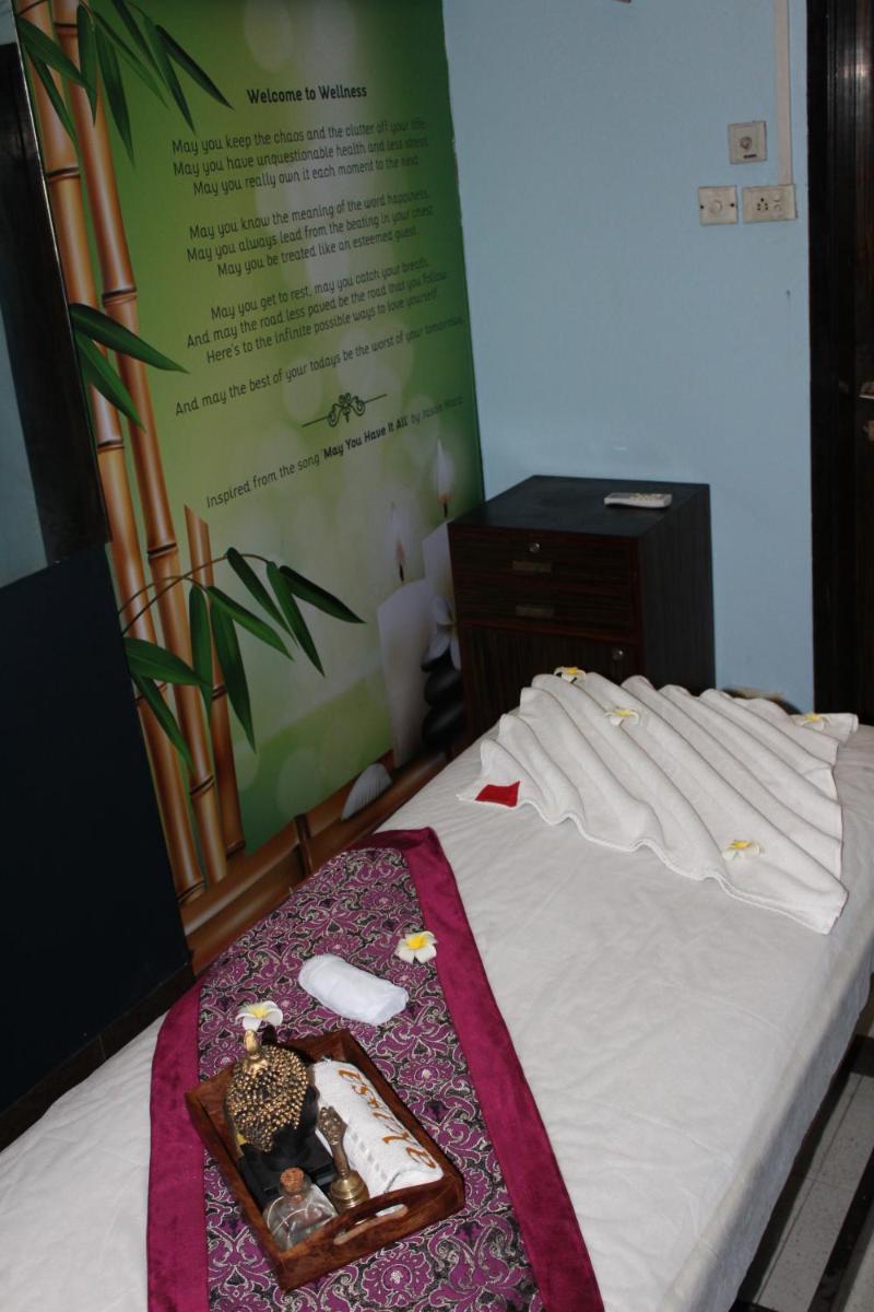 a bed with a tray of toys on top of it at Pride Plaza Hotel, Ahmedabad in Ahmedabad