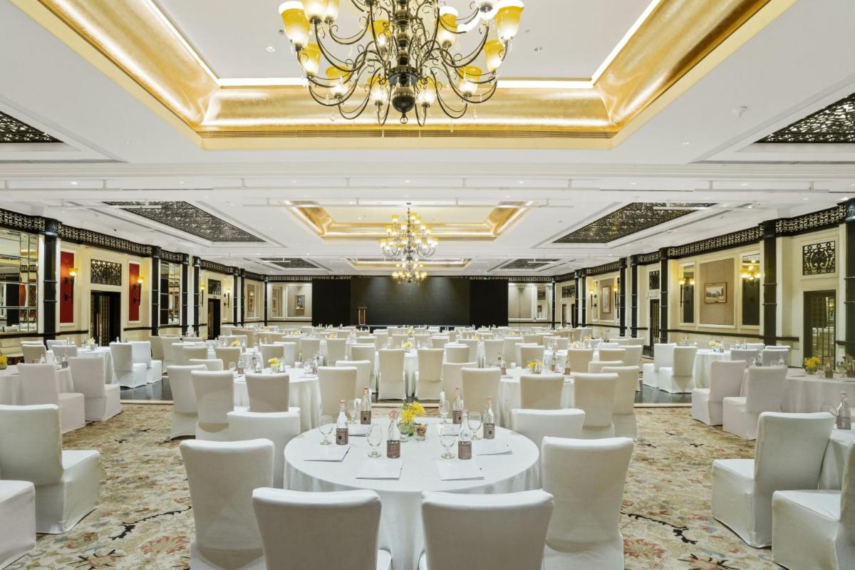 a ballroom with white tables and chairs and a chandelier at ITC Maratha, a Luxury Collection Hotel, Mumbai in Mumbai +60 photos