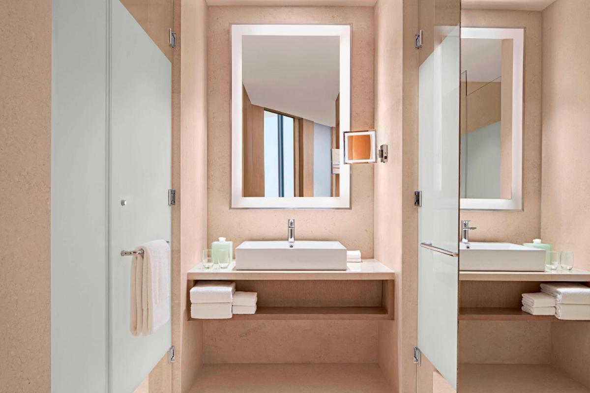 a bathroom with two sinks and a mirror at The Westin Kolkata Rajarhat in Kolkata a bathroom with two sinks and a mirror at The Westin Kolkata Rajarhat in Kolkata