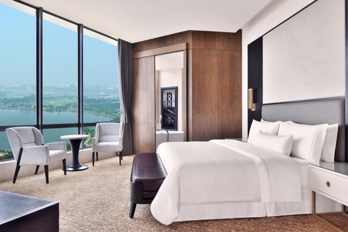 a bedroom with a large white bed and a large window at The Westin Kolkata Rajarhat in Kolkata a bedroom with a large white bed and a large window at The Westin Kolkata Rajarhat in Kolkata