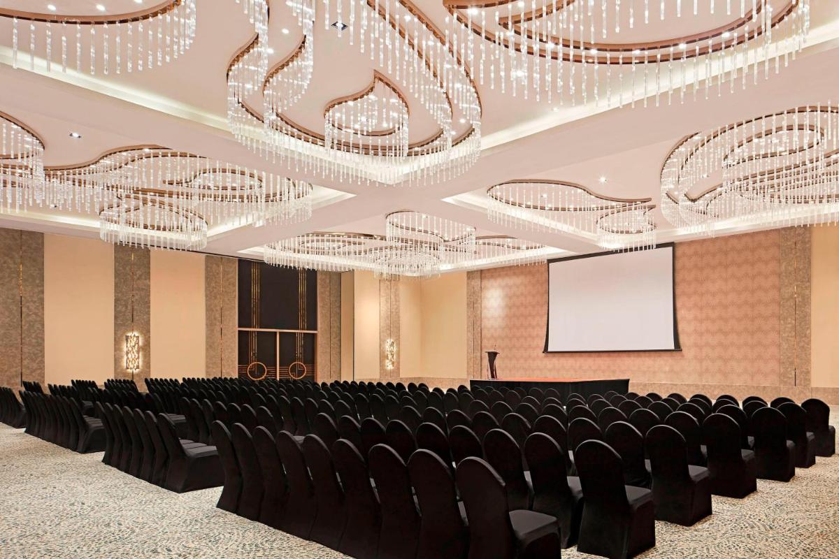 a conference room with black chairs and chandeliers at The Westin Kolkata Rajarhat in Kolkata a conference room with black chairs and chandeliers at The Westin Kolkata Rajarhat in Kolkata