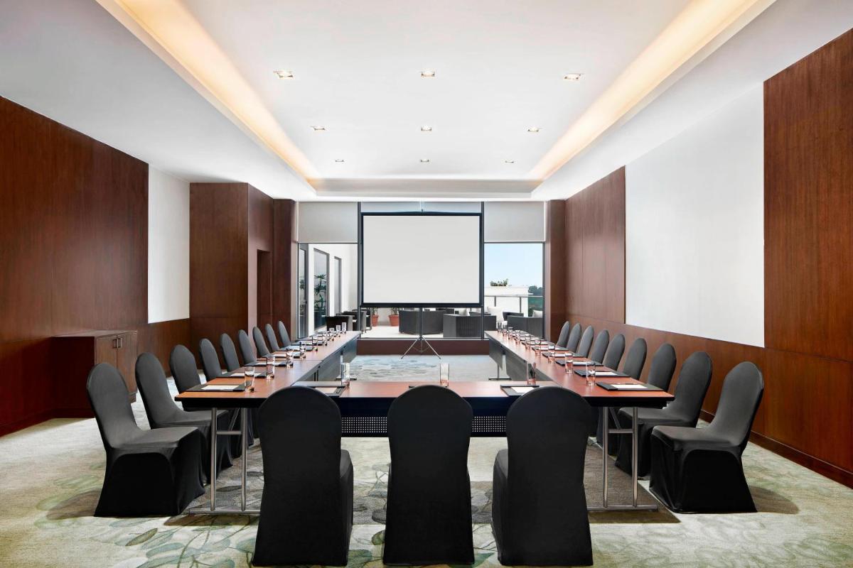 a large conference room with a long table and chairs at The Westin Kolkata Rajarhat in Kolkata a large conference room with a long table and chairs at The Westin Kolkata Rajarhat in Kolkata