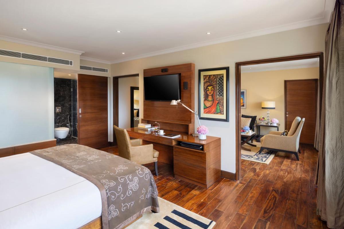 a hotel room with a bed and a desk at Taj Palace, New Delhi in New Delhi a hotel room with a bed and a desk at Taj Palace, New Delhi in New Delhi