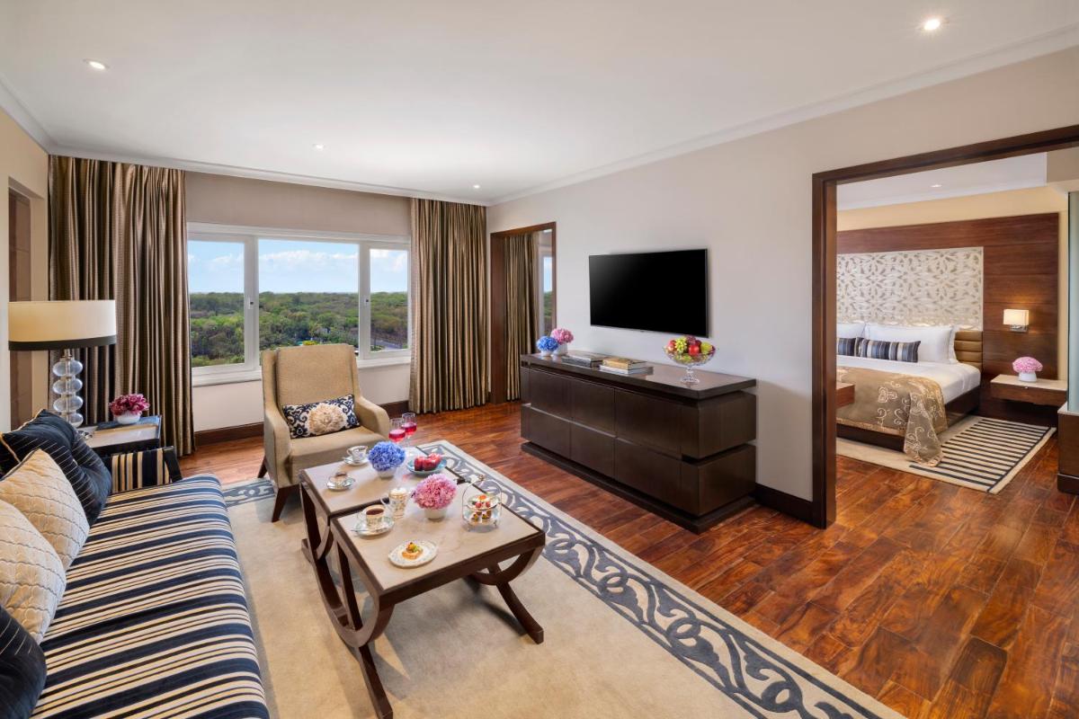 a large living room with a bed and a television at Taj Palace, New Delhi in New Delhi a large living room with a bed and a television at Taj Palace, New Delhi in New Delhi