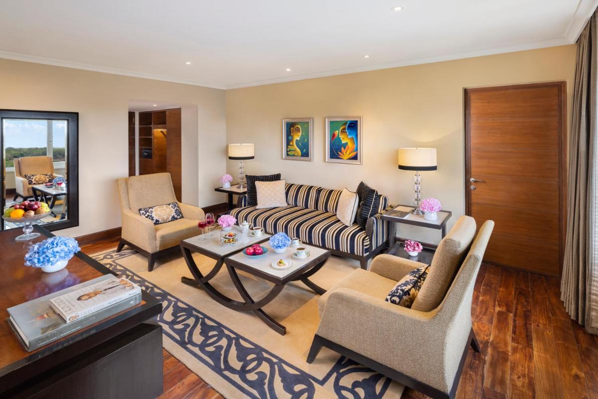 a living room with a couch and chairs and a table at Taj Palace, New Delhi in New Delhi a living room with a couch and chairs and a table at Taj Palace, New Delhi in New Delhi