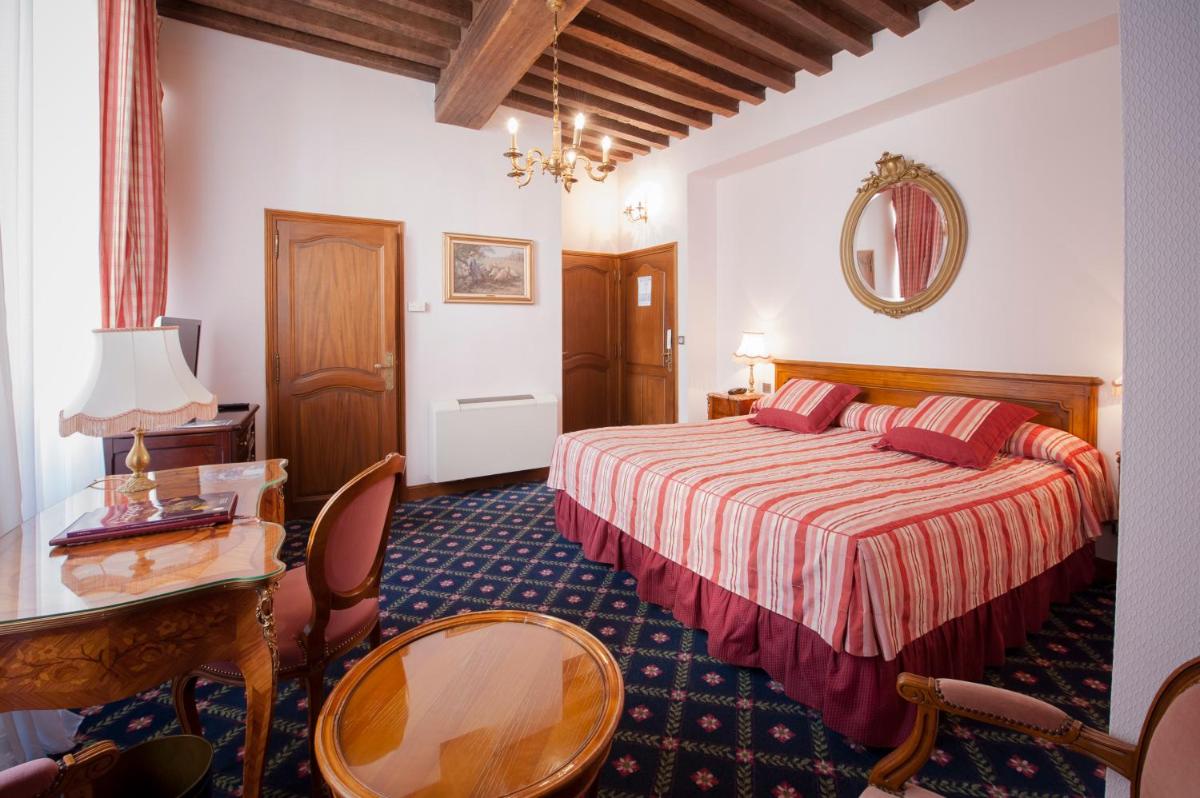 Un ou plusieurs lits dans un hébergement de l'établissement Hôtel Le Cep & Spa
