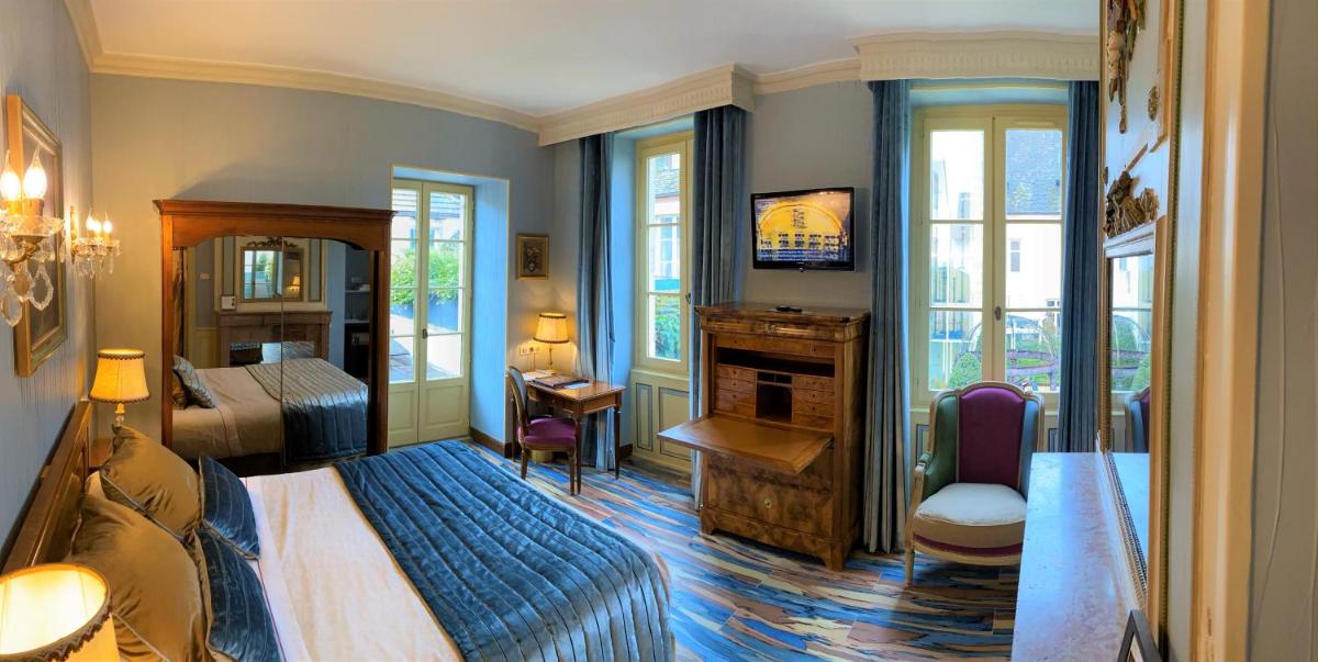 Un ou plusieurs lits dans un hébergement de l'établissement Hôtel Le Cep & Spa