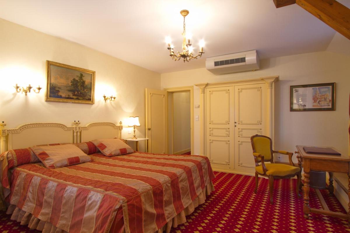Un ou plusieurs lits dans un hébergement de l'établissement Hôtel Le Cep & Spa