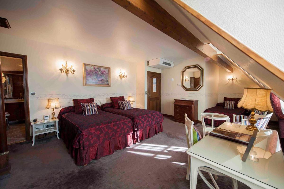 Un ou plusieurs lits dans un hébergement de l'établissement Hôtel Le Cep & Spa