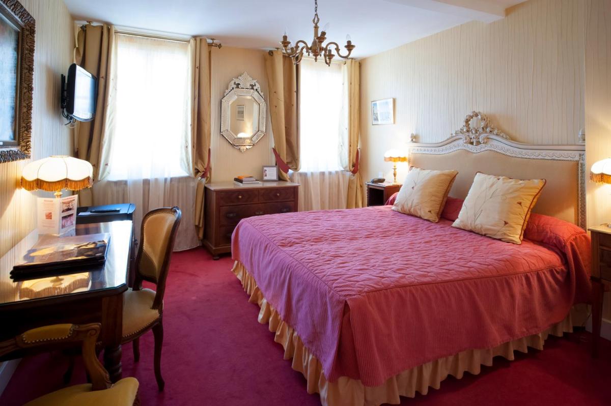 Un ou plusieurs lits dans un hébergement de l'établissement Hôtel Le Cep & Spa
