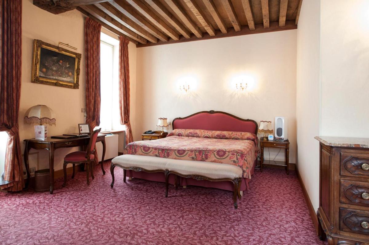 Un ou plusieurs lits dans un hébergement de l'établissement Hôtel Le Cep & Spa