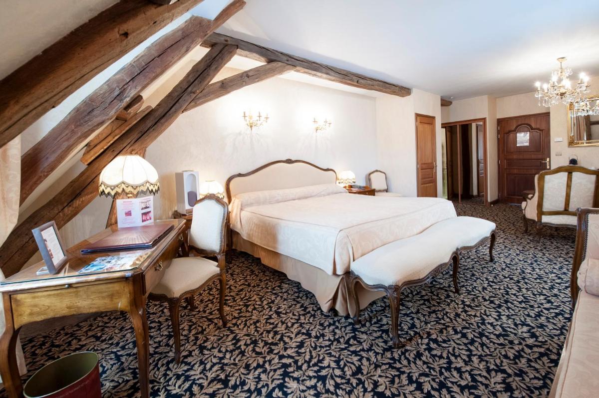 Un ou plusieurs lits dans un hébergement de l'établissement Hôtel Le Cep & Spa