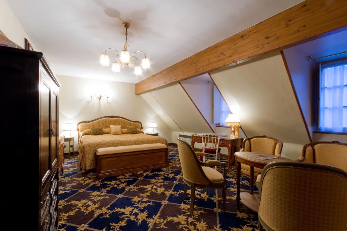 Un ou plusieurs lits dans un hébergement de l'établissement Hôtel Le Cep & Spa