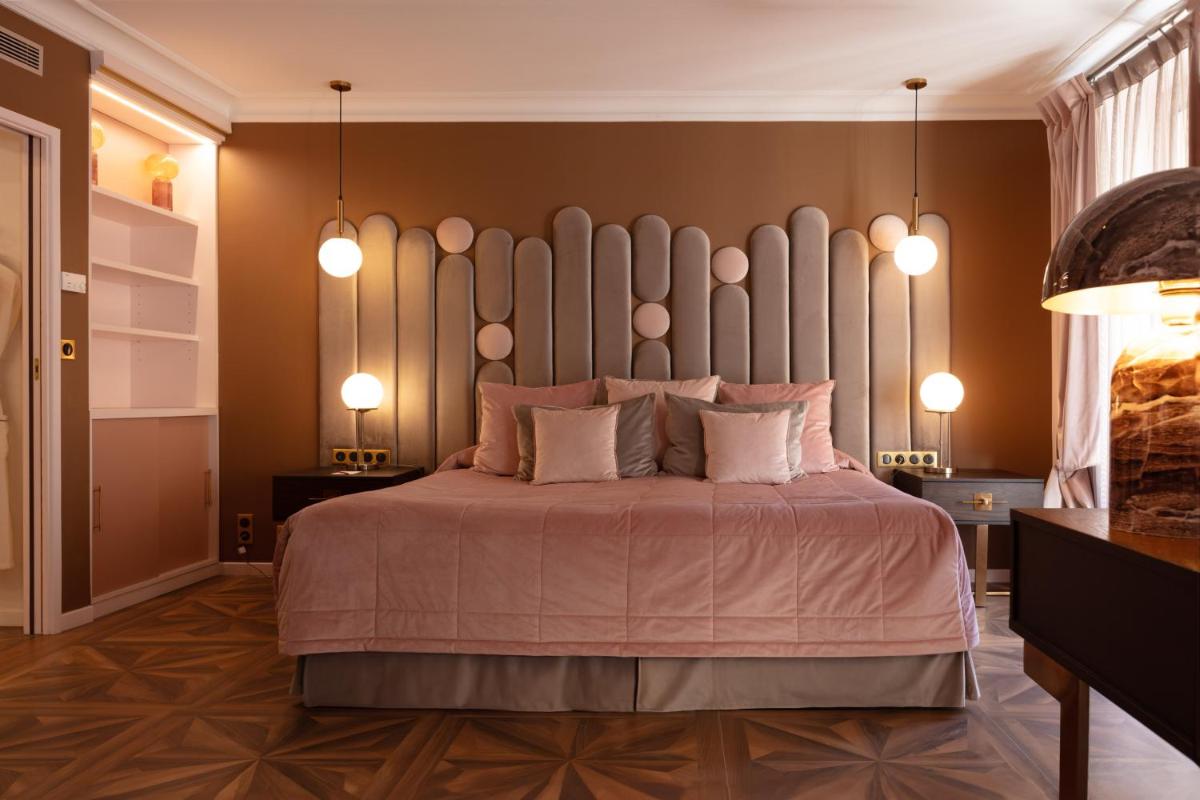 Un ou plusieurs lits dans un hébergement de l'établissement Hôtel Le Cep & Spa
